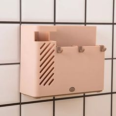 a pink box mounted to the side of a wall