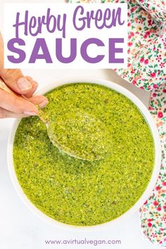 a person dipping broccoli into a white bowl with a spoon in it and the words, herb green sauce