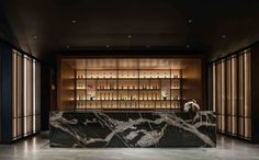 an elegant bar with marble counter tops and shelves