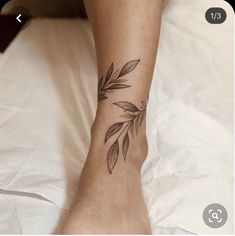 a woman's foot with a leaf tattoo on her left ankle and the bottom part of her leg