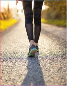 there is a woman walking down the road with her feet on the ground and text overlay