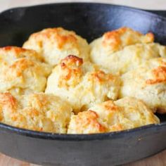 biscuits in a cast iron skillet on a wooden table