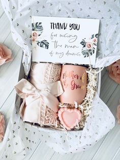 a gift box filled with personalized coffee mugs next to pink flowers and thank you note