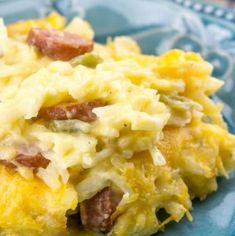 an omelet with bacon and cheese on a blue plate