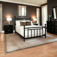 a bedroom with brown walls and white bedding