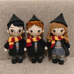 three crocheted harry potter dolls are standing next to each other on a carpet