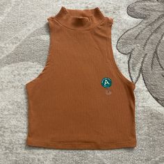 Burnt Orange Mock Neck Tank Top Never Been Worn, Still With Original Tags Trendy Brown Cotton Tank Top, Casual Brown Sleeveless Crop Top, Brown Fitted Casual Tank Top, Casual Crop Top Tank For Fall, Casual Fall Crop Top Tank, Casual Brown Stretch Tank Top, Casual Brown Cropped Tank Top, Casual Sleeveless Crop Top, Casual Sleeveless Crop Top For Fall