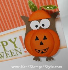 an orange and brown owl with a pumpkin on it's head is standing in front of a happy halloween card