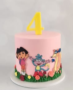 a pink birthday cake with cartoon characters on it