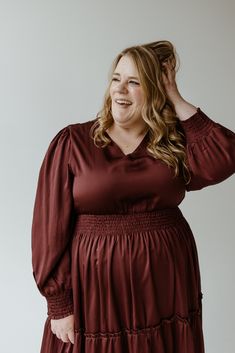 Looking for the perfect party piece? This Zinfandel blouson dress is the one! With its modest v-neck, smocked waist, and roomy tiers, it'll have you twirling with flair. Fun and flattering, this midi length dress is a real show-stopper! We suggest going up a size from your typical. Leslie is wearing a size 3x. Want more information about the model? Visit our Lovely Models page. Wash Hand wash in cold water, separately. Turn inside out. Hang to dry. Low iron if needed. Do not bleach. Fabric Self: 100% Polyester Contrast: 100% Polyester Measurements Size Bust Sleeve Length Waist Hip Body Length L 40" 24.5" 32" 56" 54" xL 42" 25" 34" 60" 54" 2x 46" 25" 36" 68" 54.5" 3x 48" 25" 40" 72" 54.5" *We understand that each body type is different, so posted above are measurements. These measurements a Elegant V-neck Midi Dress With Elastic Waistband, Elegant Party Dresses With Elastic Waistband, Casual Party Dress With Elastic Waistband, Flowy V-neck Dress With Smocked Cuffs, Fall V-neck Dress With Smocked Back, V-neck Midi Dress With Elastic Waistband For Brunch, Elegant V-neck Dress With Elastic Waistband, Chic V-neck Dress With Elastic Waistband, V-neck Dress With Smocked Back For Fall