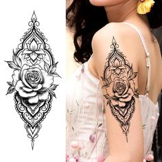 a woman's shoulder tattoo with roses on it