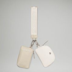 two white luggage tags attached to each other on a lanyard or keychain