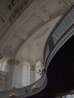 an ornate ceiling with chandeliers and windows