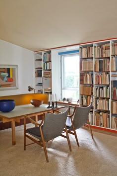 a room filled with lots of books and furniture