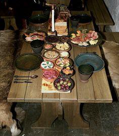 a wooden table topped with lots of food