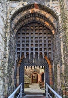 the entrance to an old castle with stone walls