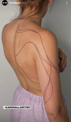 the back of a woman's shoulder with lines drawn on it