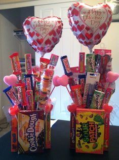 two valentine's day candy bouquets with heart shaped balloons and candy bar wrappers