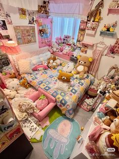 a room filled with lots of stuffed animals and other stuff items on the floor next to a bed