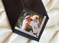 an old man and young child are wearing a neck tie with a photo on it