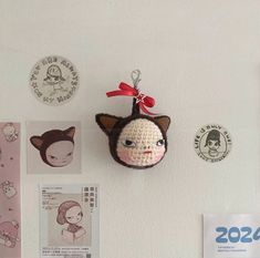 there is a stuffed animal hanging on the wall next to other magnets and badges