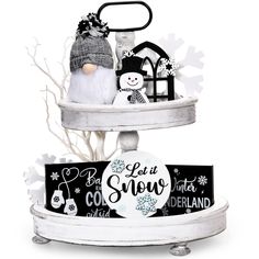 a white shelf with two snowmen on it and a sign that says let it snow