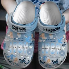 a pair of blue shoes that say your name and are decorated with butterflies on them