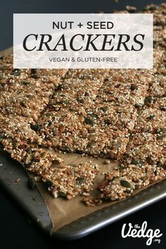 a close up of a tray of crackers on a table with the words nut and seed crackers over it