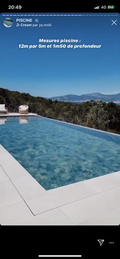 a large swimming pool surrounded by trees and mountains