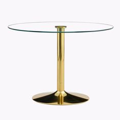 a round glass table with a gold metal base on a plain white background the top is circular