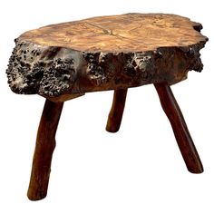 a piece of wood sitting on top of a wooden table covered in tree stumps