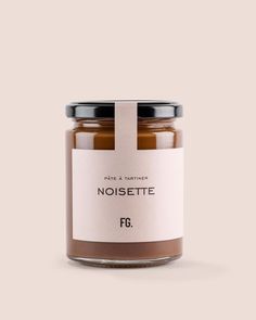 a jar of noisette with a label on the front and bottom, sitting on a white surface