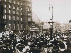 an old black and white photo of people in the street with one person holding a sign that says women's suffrage