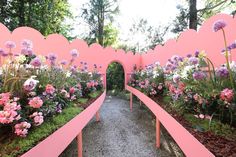 a pink garden with benches and flowers