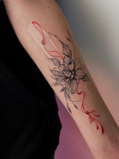 a woman's arm with a flower tattoo on the left side of her arm