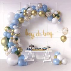 a baby shower with blue, white and gold balloons in the shape of a circle