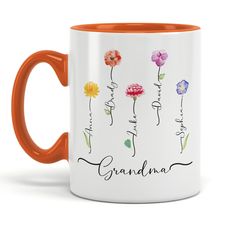 an orange and white coffee mug with the words grandma written on it, surrounded by flowers