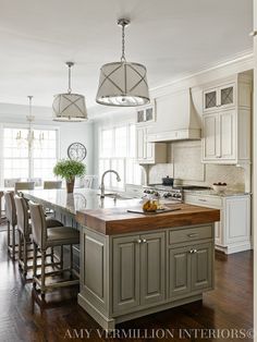 a large kitchen with an island in the middle