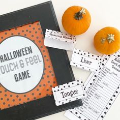 halloween touch and feel game with pumpkins on the table next to it, along with other items