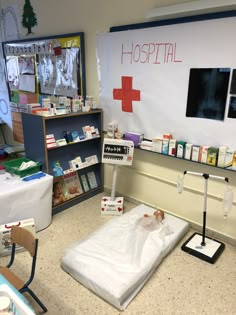 a hospital room with a bed and medical supplies on the floor in front of it