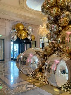 a large number of shiny balls hanging from the ceiling