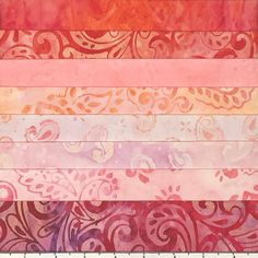 an assortment of pink, orange and purple paper with different designs on it's sides