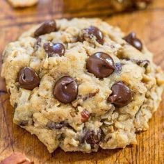 a chocolate chip cookie on a wooden table