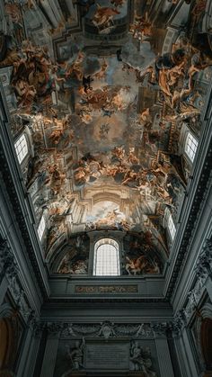 an ornate ceiling with paintings on it in a room that is painted black and white