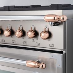 an oven with five knobs and four burners