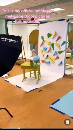 an image of a photo studio set up with chairs and umbrellas on the floor