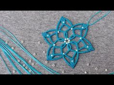 a close up of a piece of cloth with beads on it and a star ornament