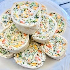 vegan veggie pinwheels on a white plate with text overlay