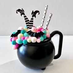 a black pot filled with candy and candies