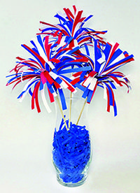 a vase filled with red, white and blue streamers